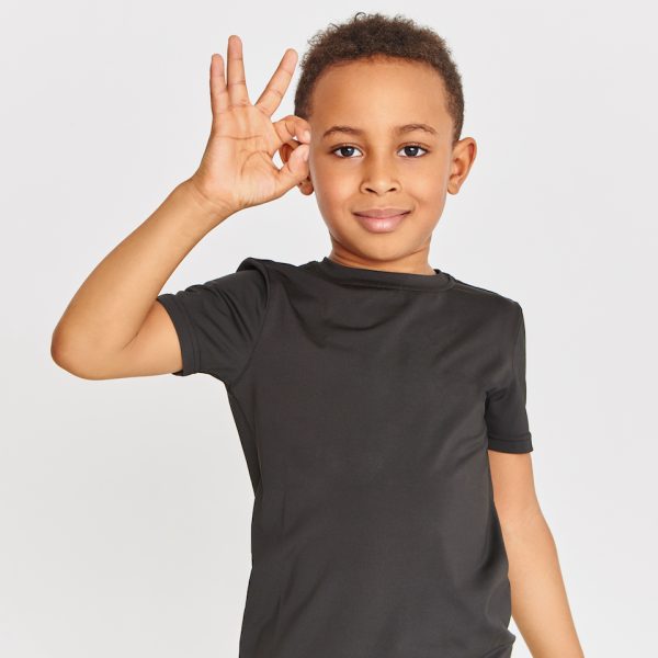 Body language. Portrait of friendly looking positive dark skinned little boy in t-shirt connecting fore finger and thumb making approval gesture, showing okay sign, saying Everything is fine Body language. Portrait of friendly looking positive dark skinned little boy in t-shirt connecting fore finger and thumb making approval gesture, showing okay sign, saying Everything is fine